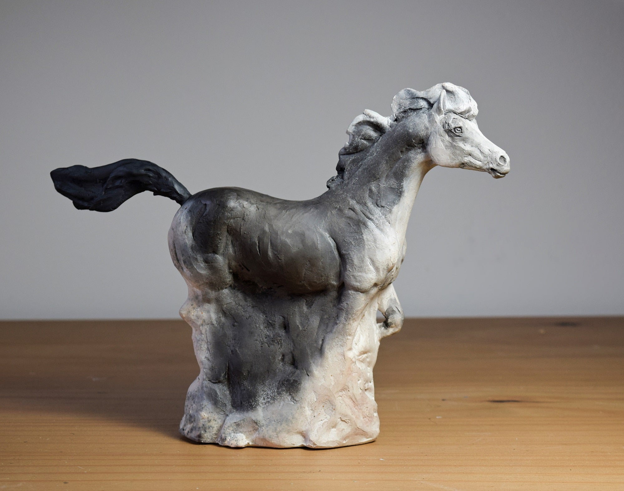 Smoke fired ceramic horse sculpture by Susie Benes