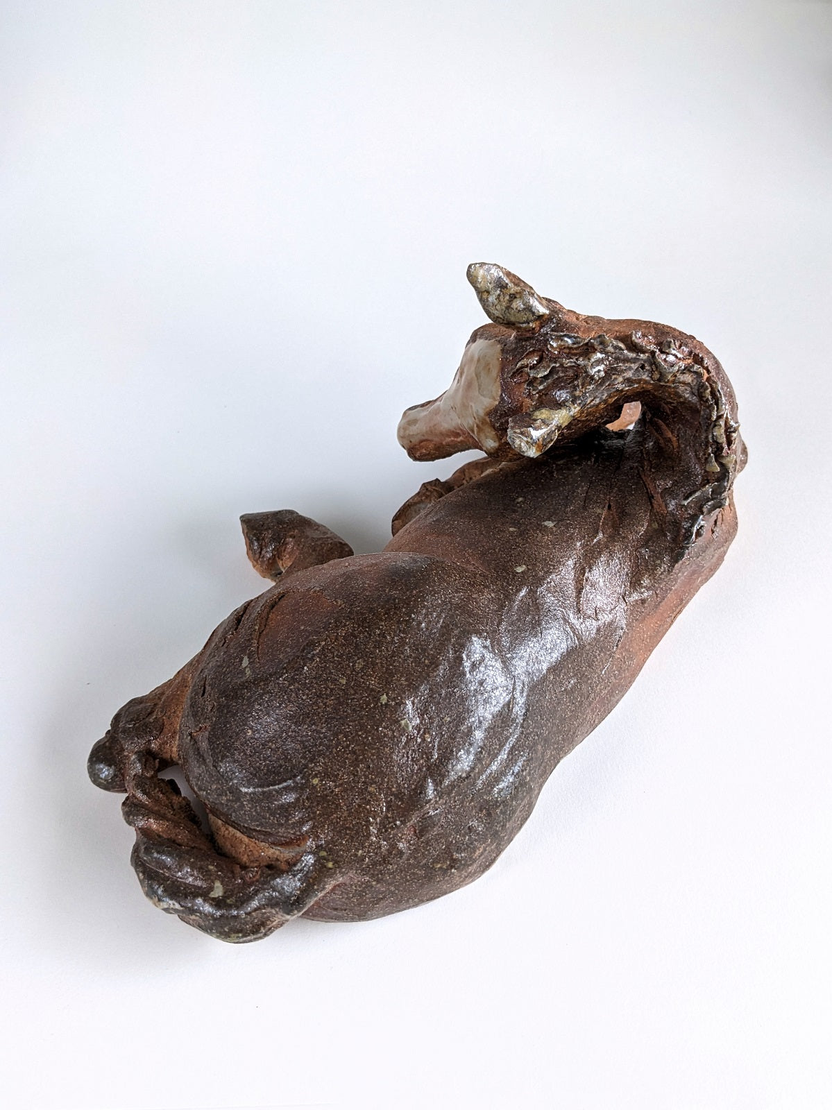 Wood fired ceramic sleeping foal horse sculpture by Susie Benes