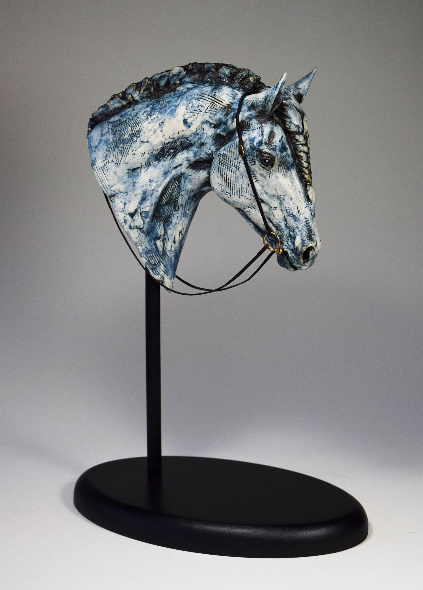 Blue ceramic horse head with braid sculpture by Susie Benes