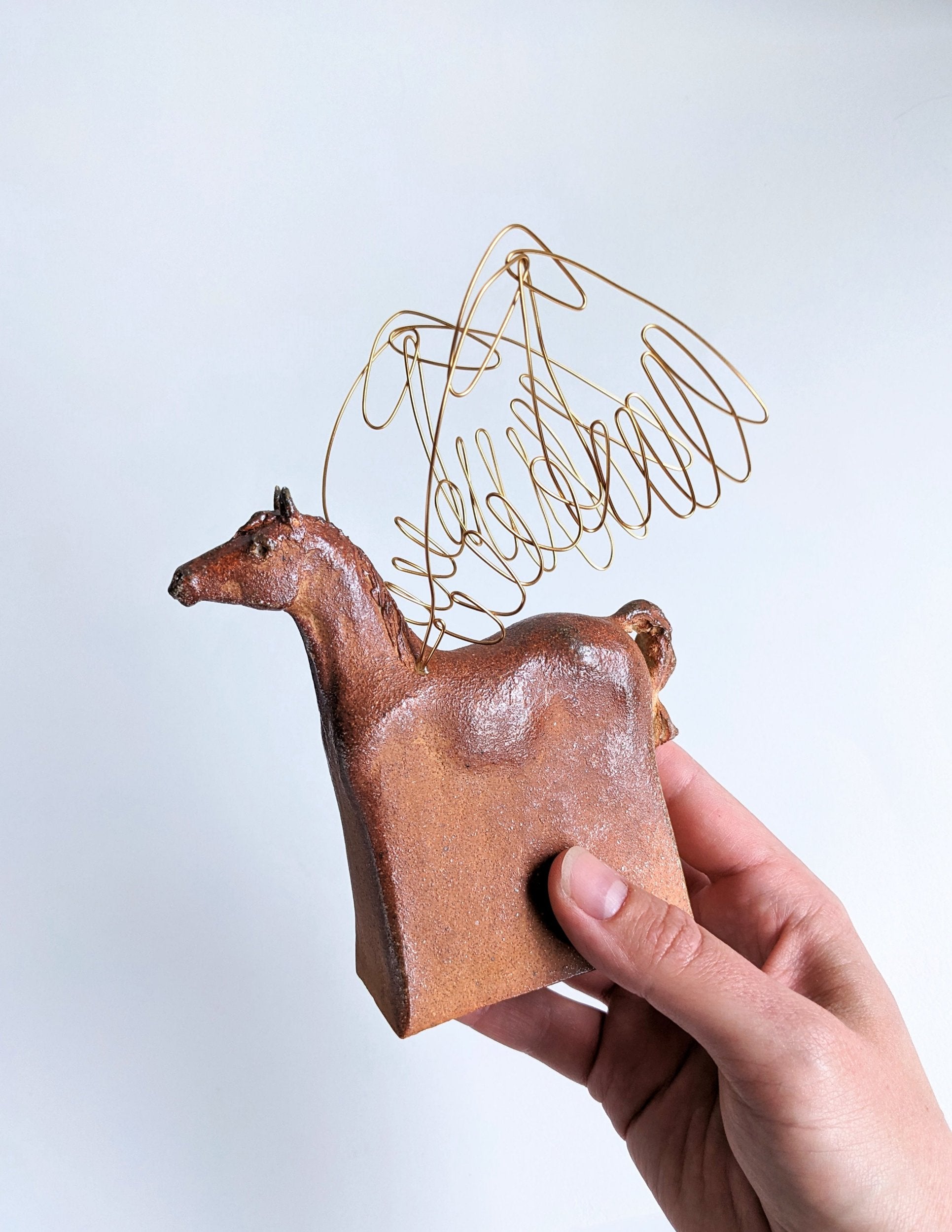 Warm brown wood fired ceramic pegasus horse sculpture