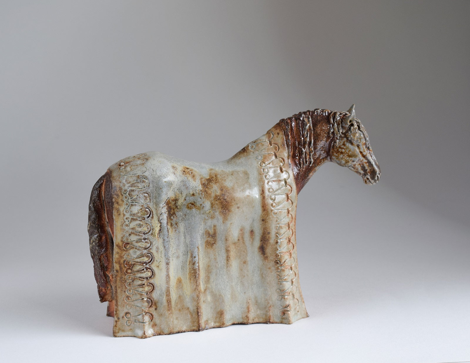 Wood fired ceramic horse with blanket sculpture by Susie Benes