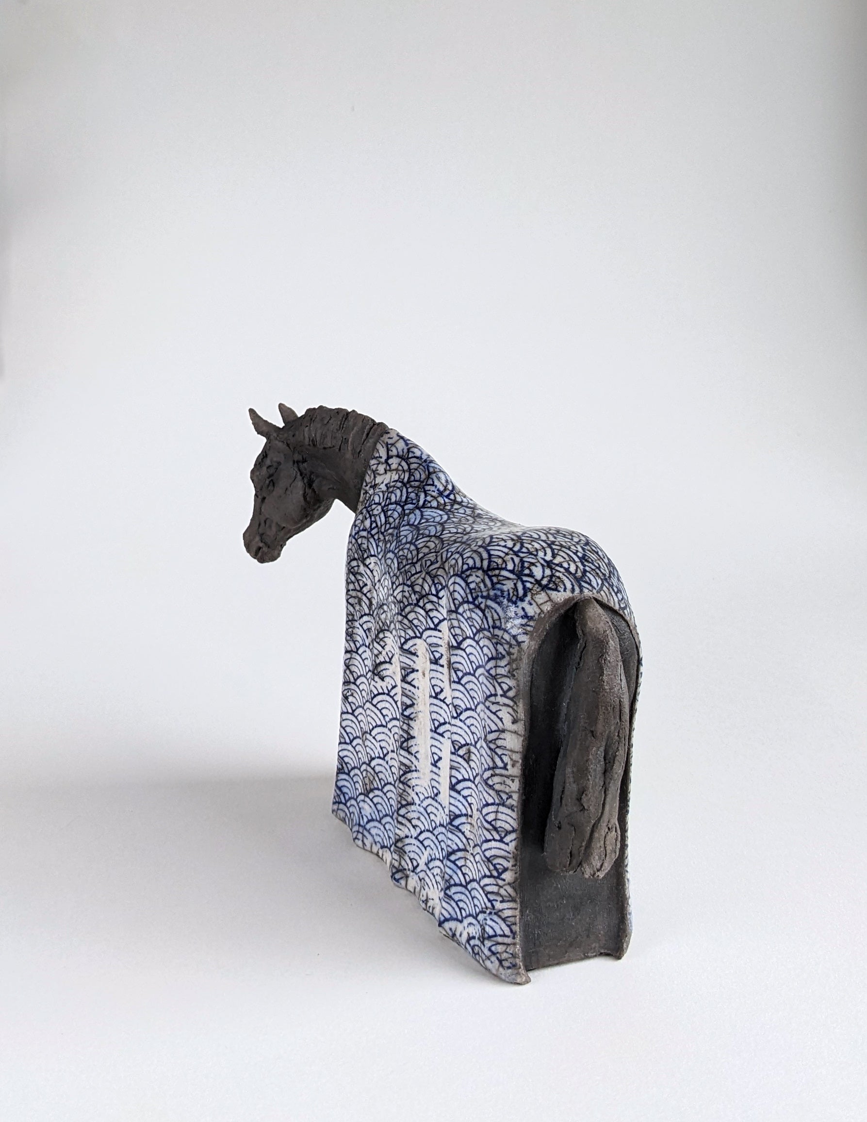 Black horse sculpture with Japanese blue design