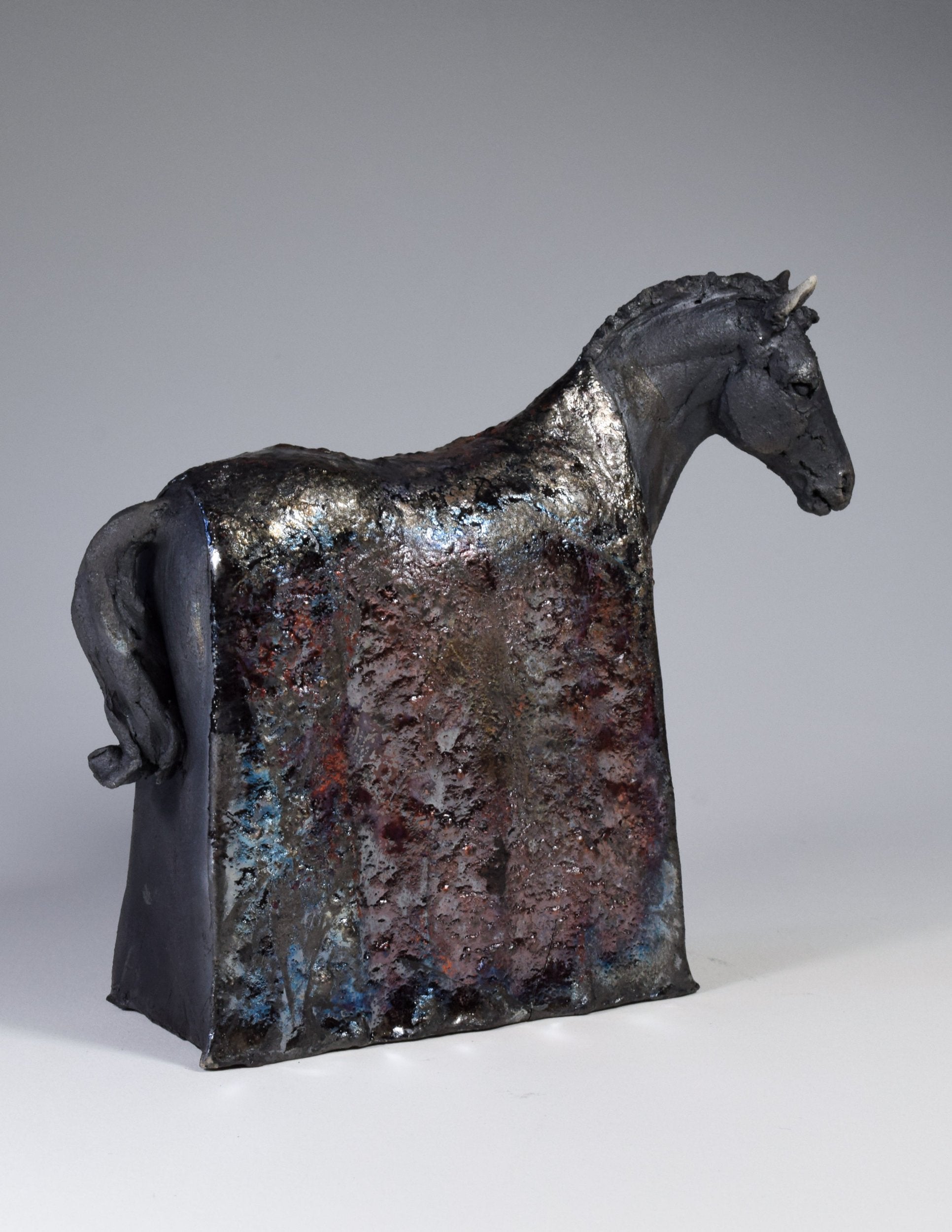Ceramic raku horse sculpture with metallic blanket by Susie Benes