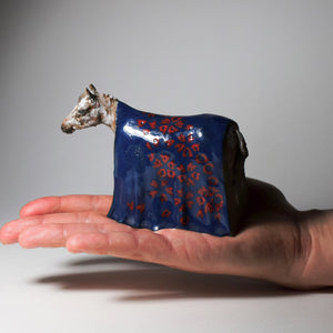 Small ceramic horse with blue blanket sculpture